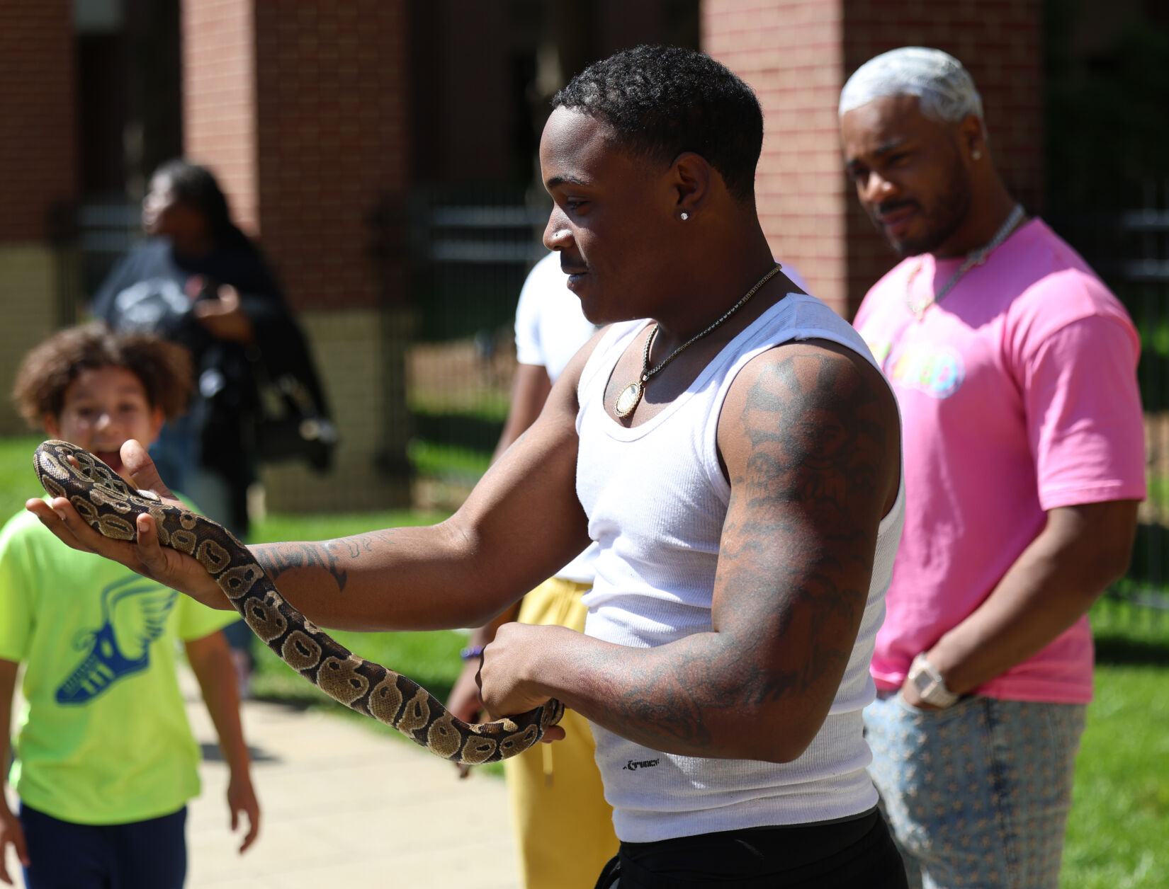 Man holds snake at Pegasus Parade.JPG